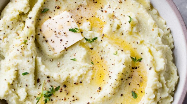 Mashed cauliflower topped with butter and fresh parsley.