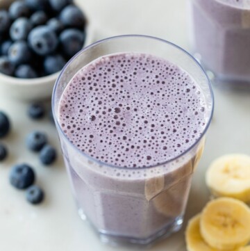 Glass with a blueberry banana smoothie.