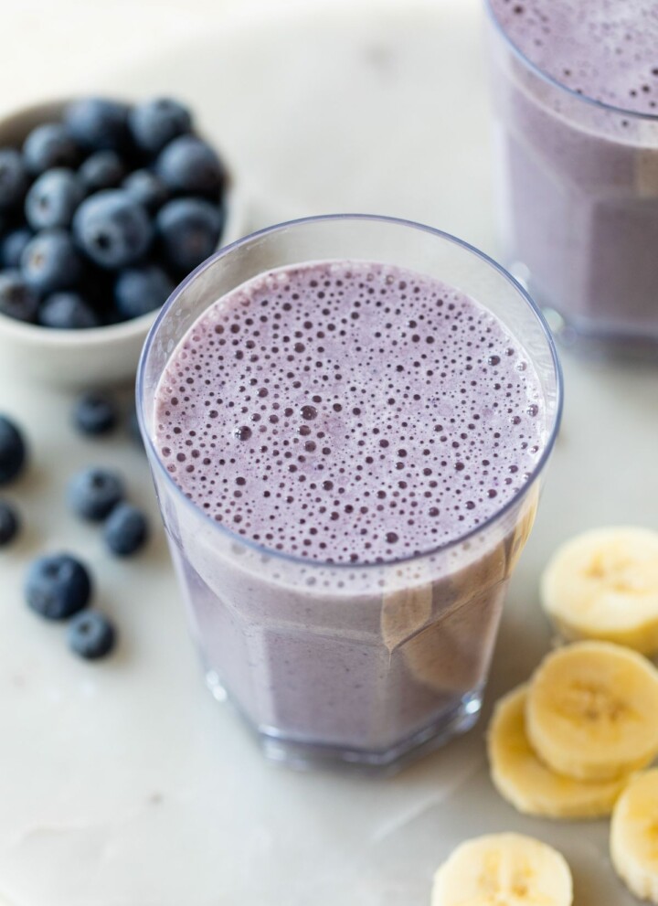 Glass with a blueberry banana smoothie.