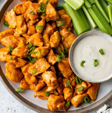 Buffalo chicken bites served with ranch dressing and celery sticks.