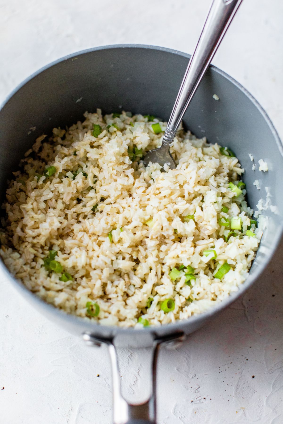 Fluffing rice with a fork.