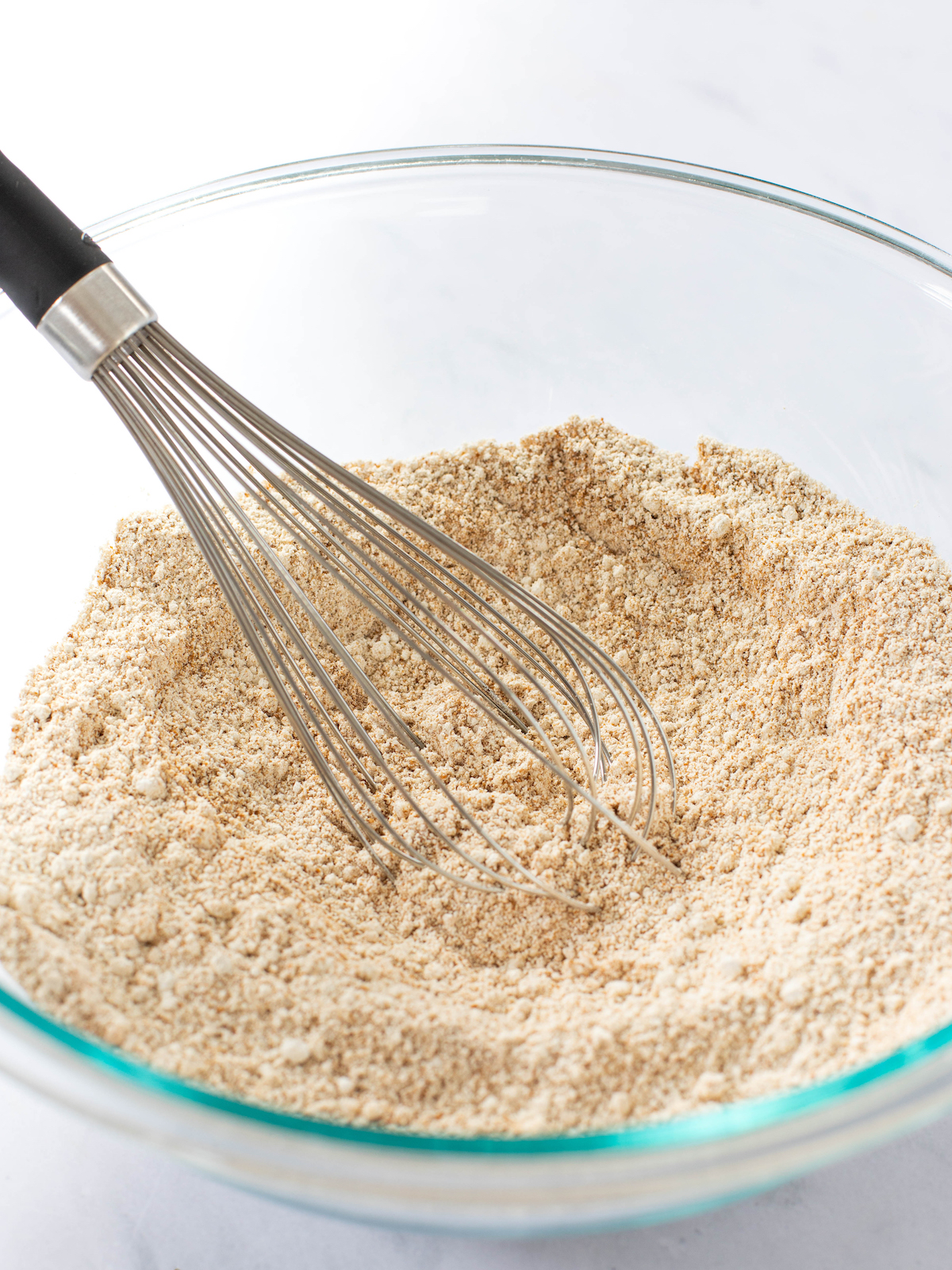 Whisking dry ingredients in a large bowl.