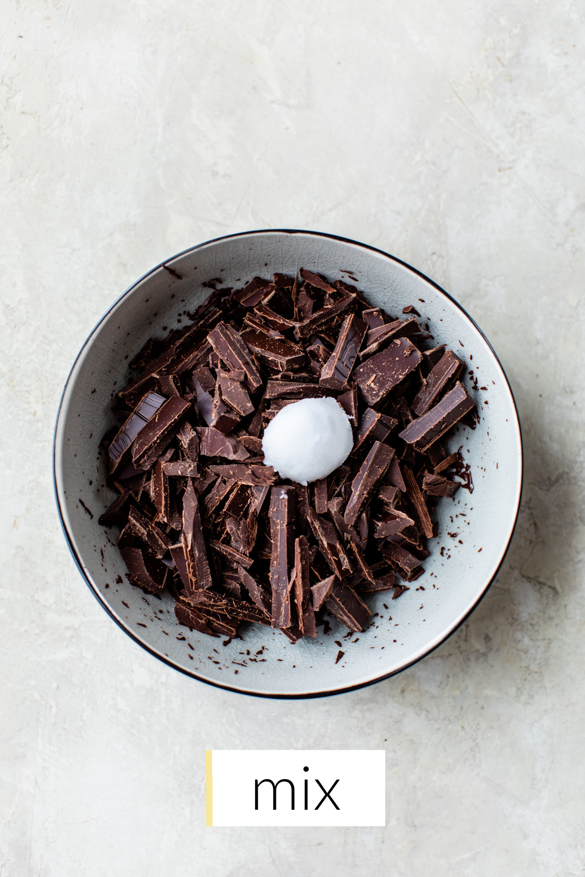 dark chocolate and coconut oil in a small white bowl.