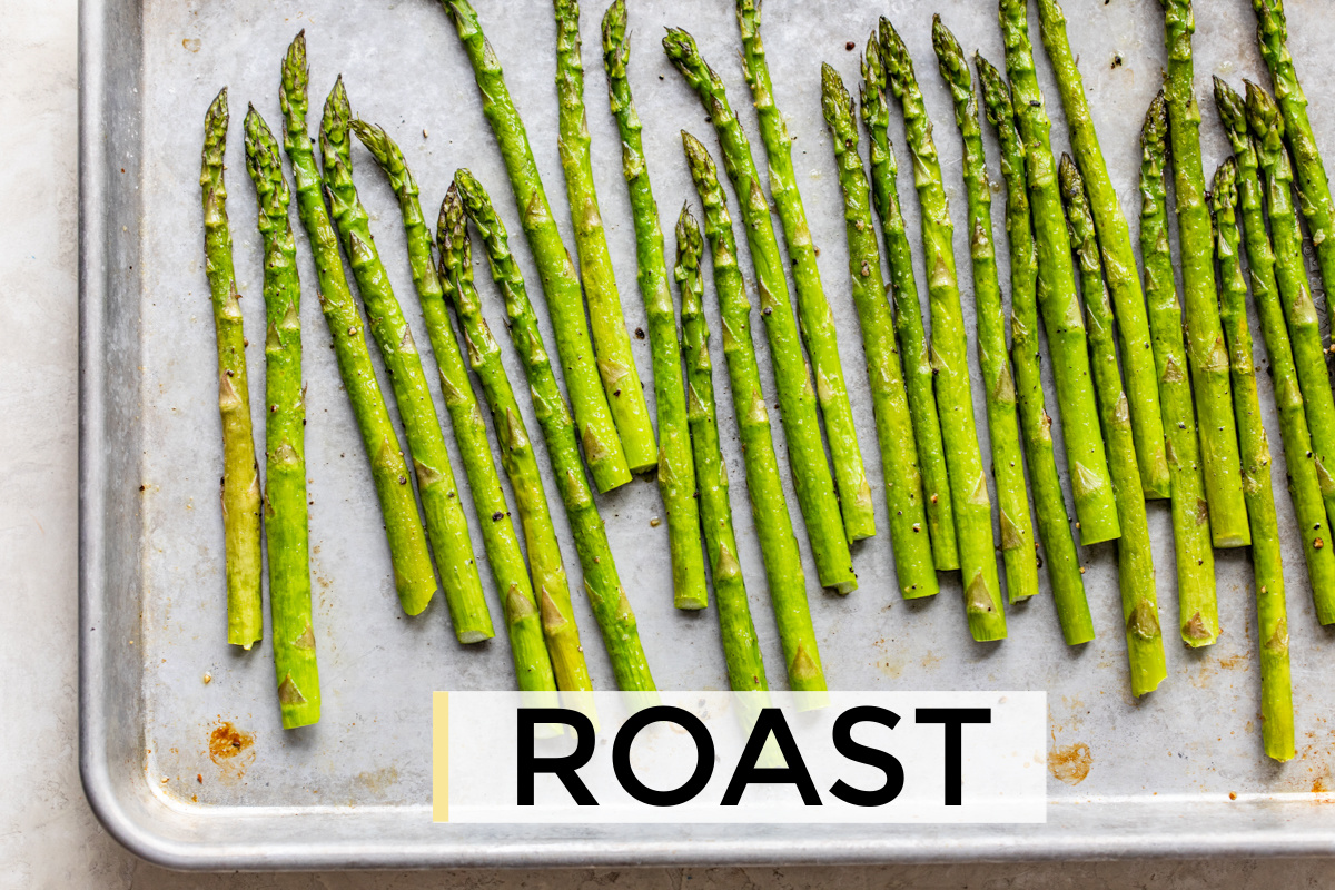 freshly roasted asparagus on a rimmed baking sheet.