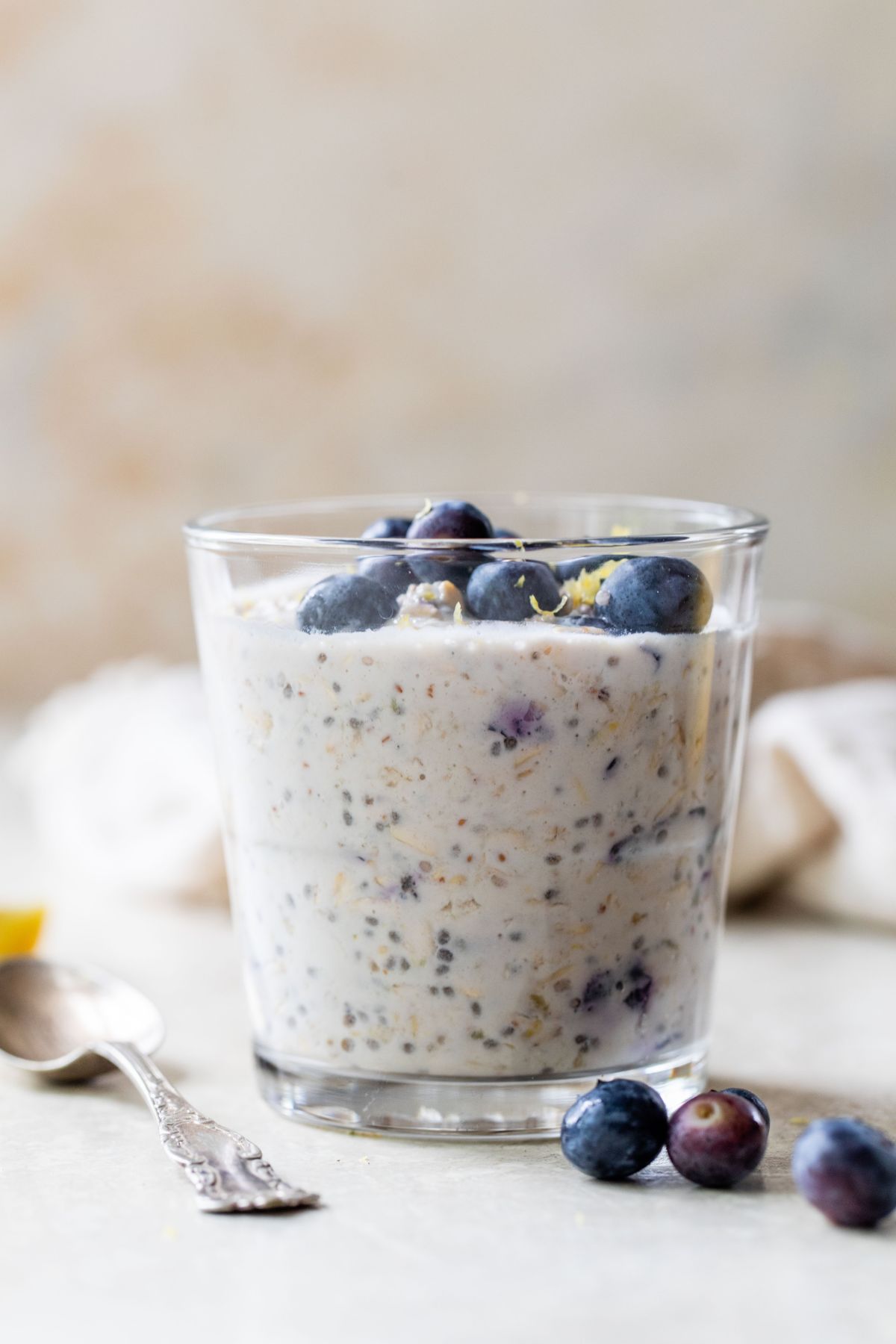 Side view of blueberry overnight oats in a glass.