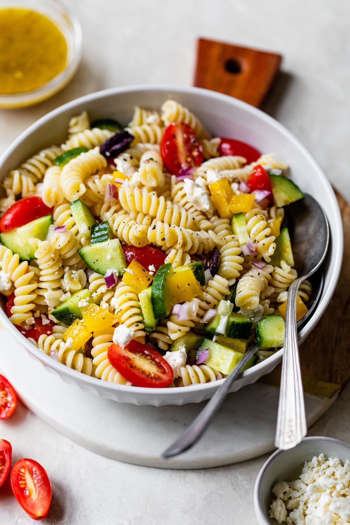 Pasta salad with tomatoes, cucumbers and bell pepper.