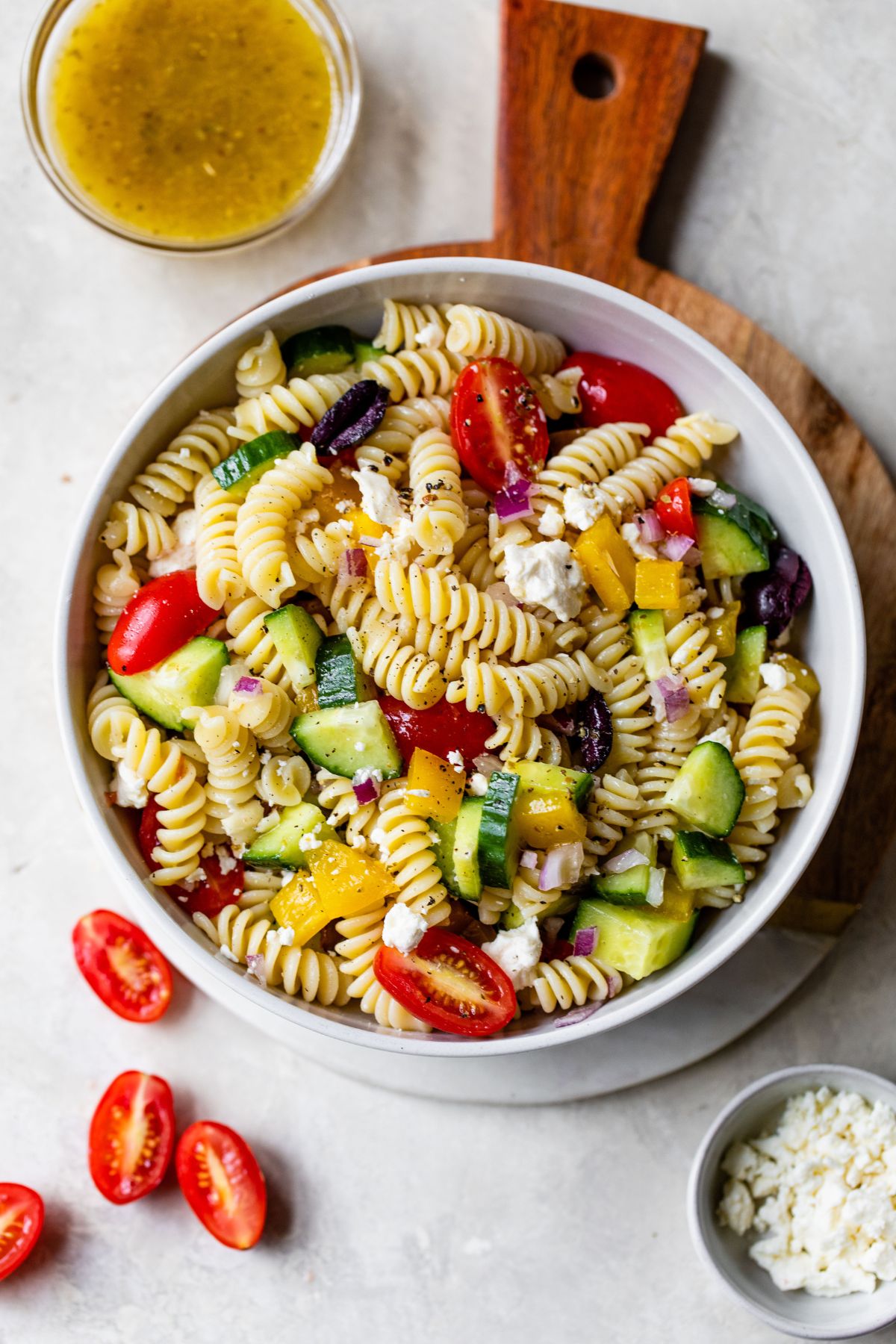Greek pasta salad made with black olives, grape tomatoes, cucumber and feta cheese.