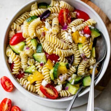 Greek pasta salad served in a white bowl.