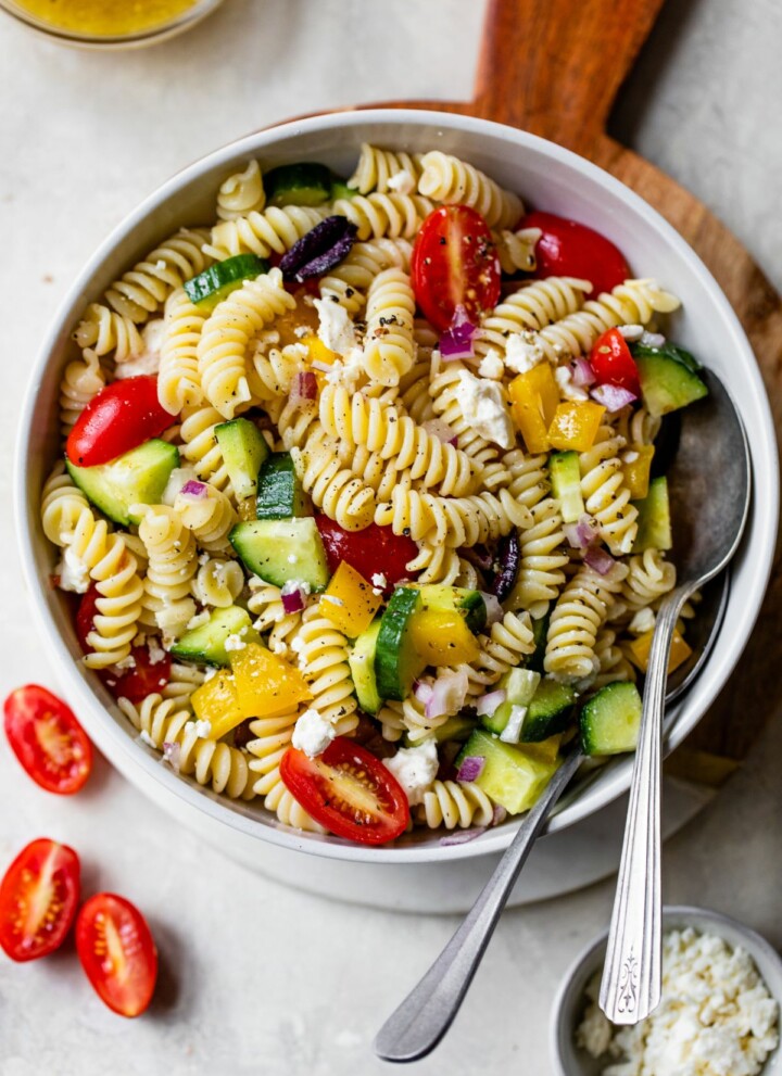 Greek pasta salad served in a white bowl.