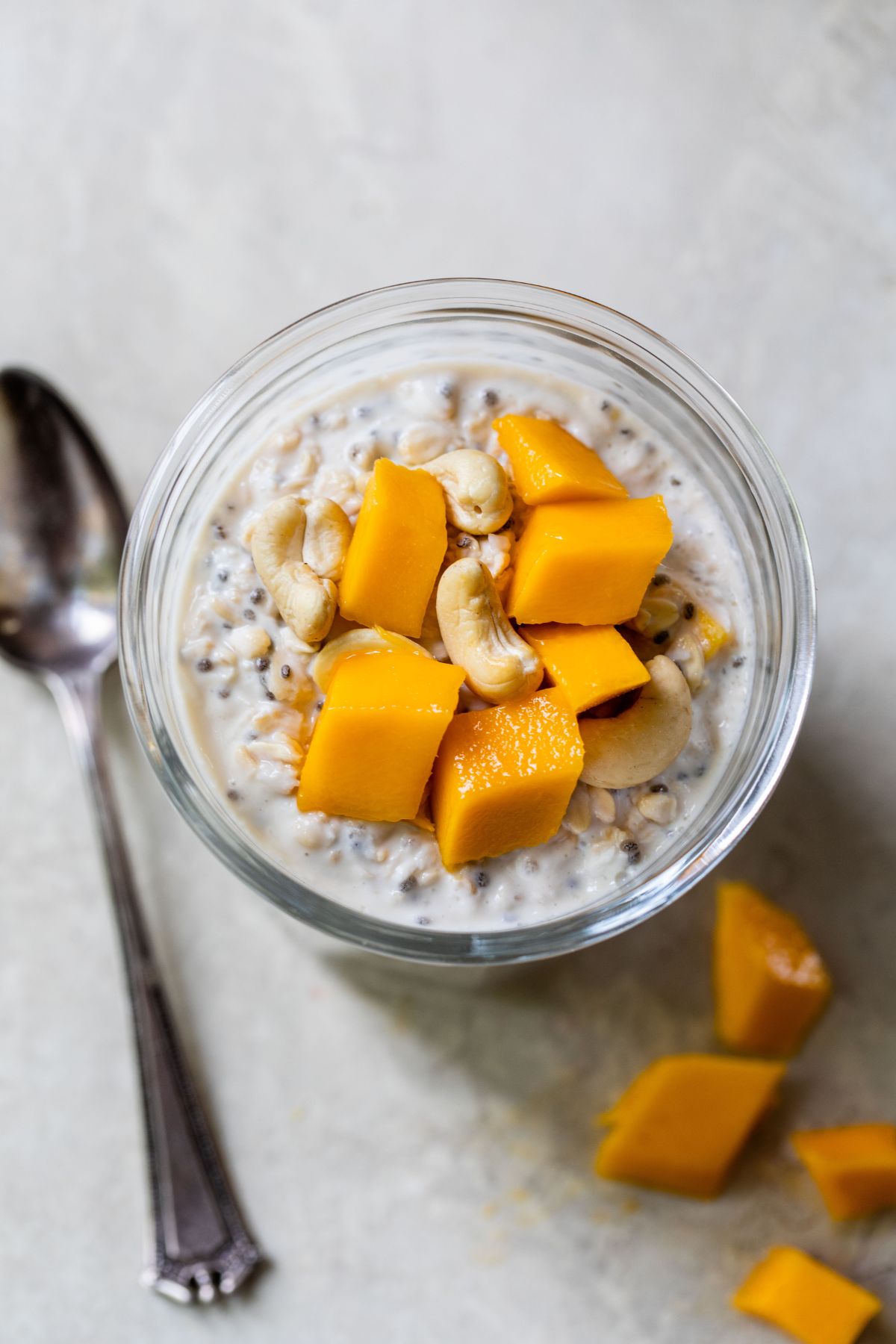 Mango overnight oats served with cashews on top.