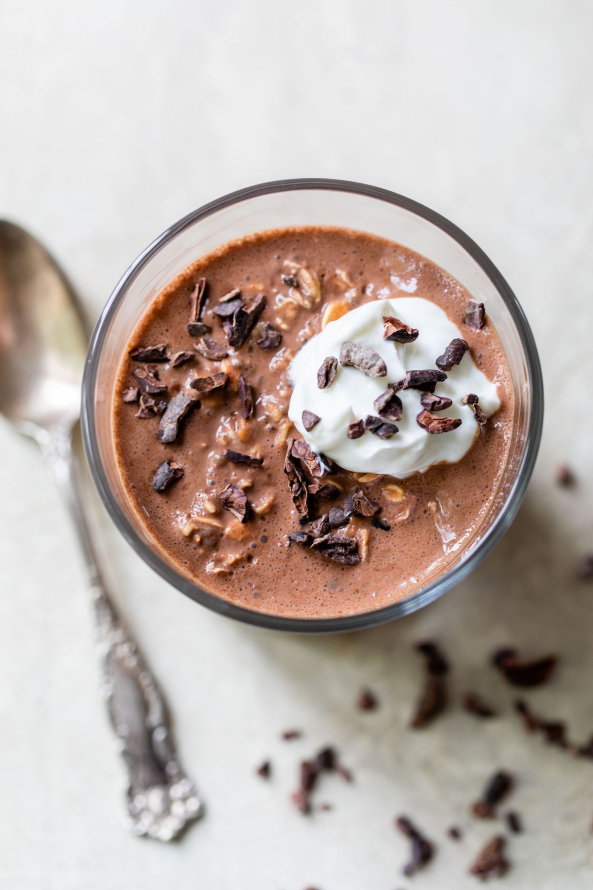 Chocolate overnight oats topped with greek yogurt and cacao nibs.