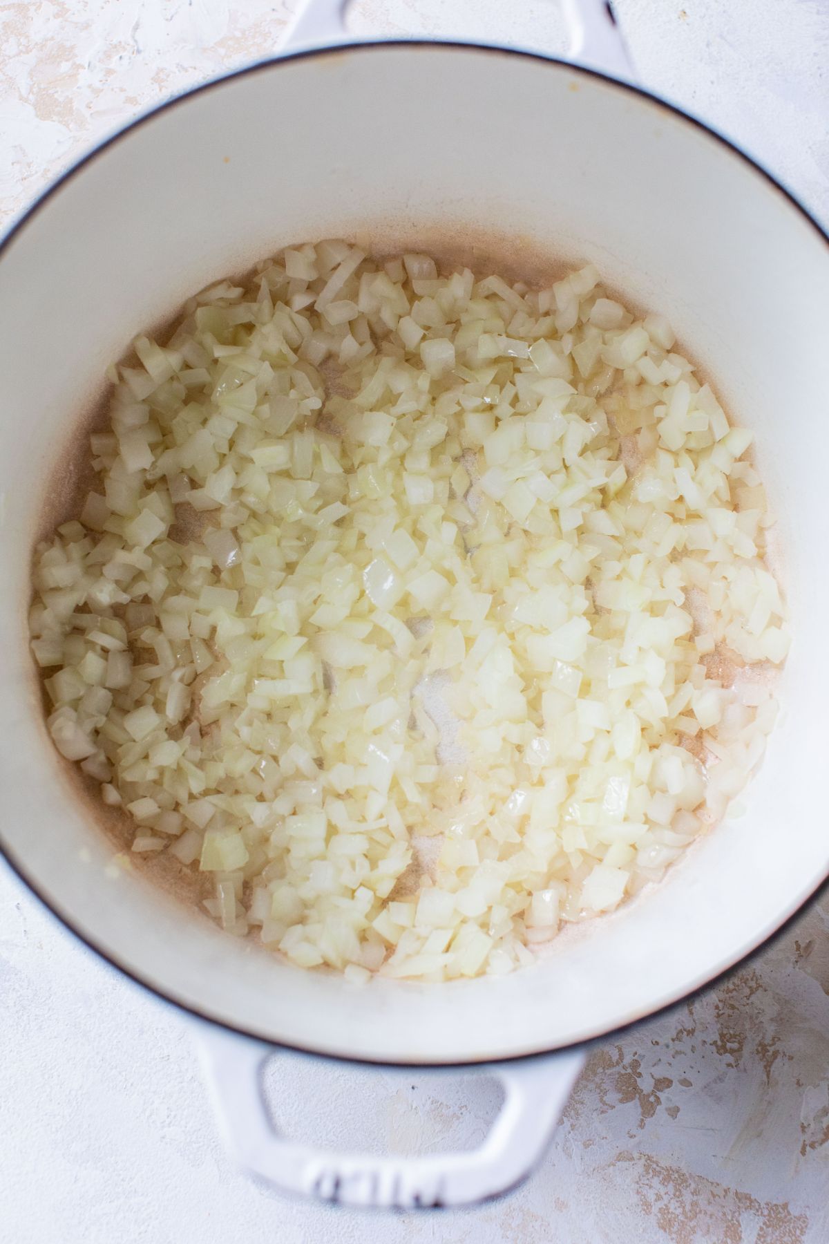 Sautéing onions in a large pot.