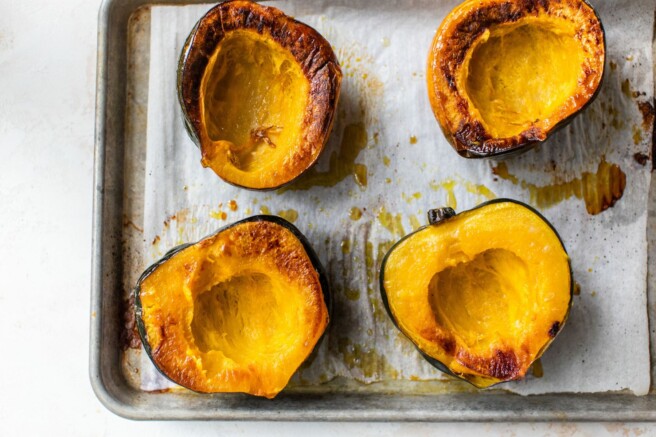 Roasted acorn squash on a pan.