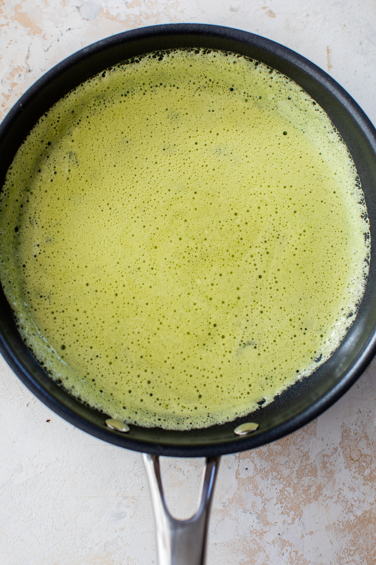 green eggs poured into an 8-inch skillet