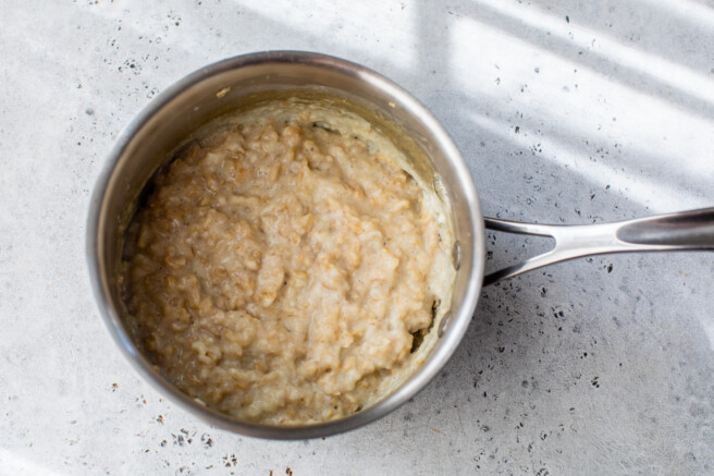savory breakfast oats cooked in a small pot