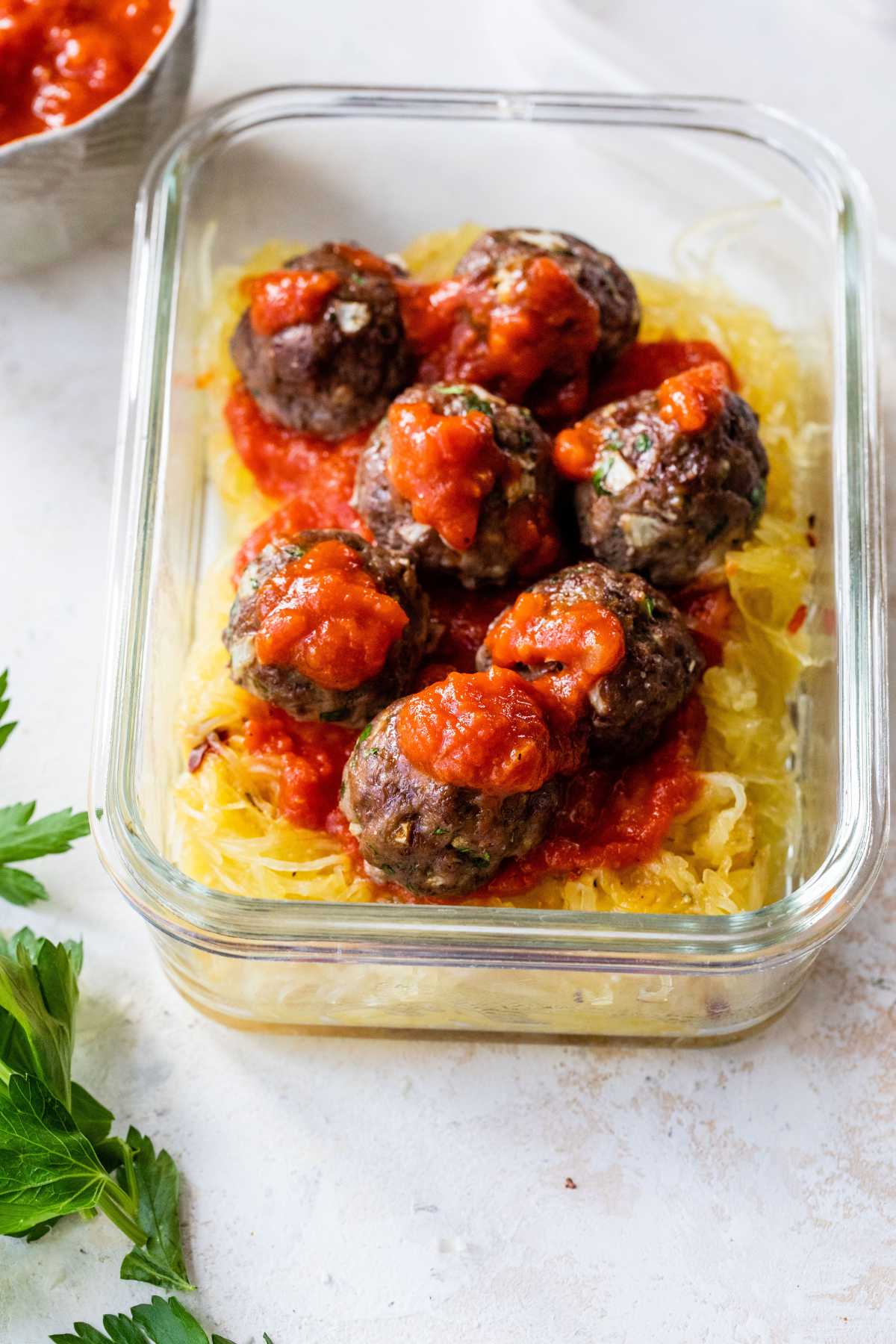 Meatballs served over spaghetti squash with red sauce.