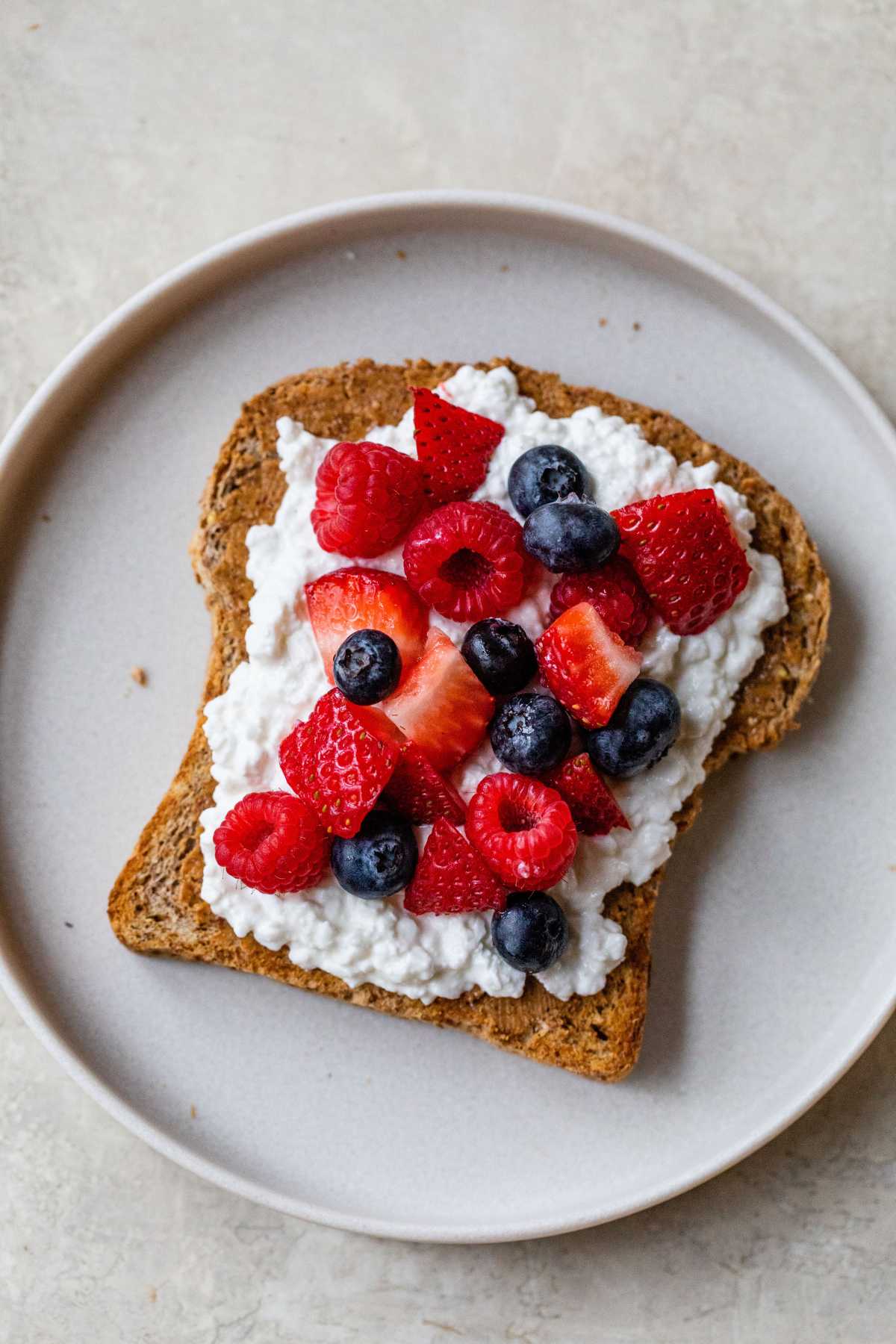 Cottage cheese toast topped with almond butter, cottage cheese and mixed berries.