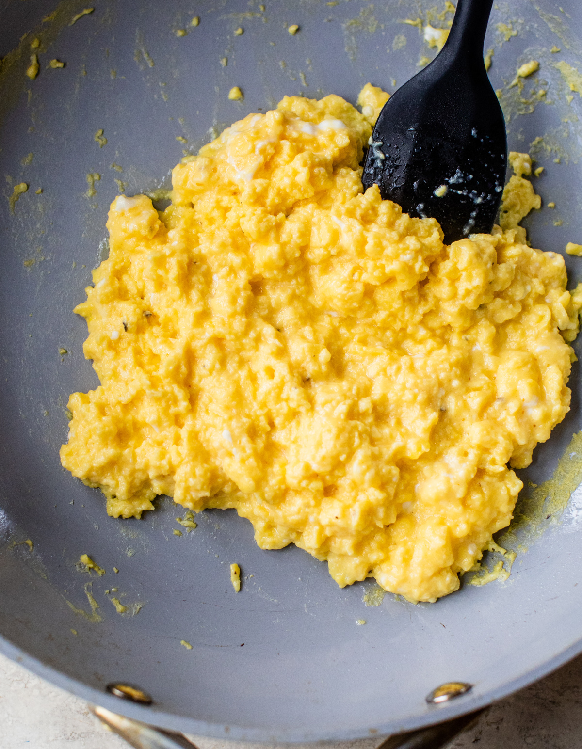 scrambled eggs with cottage cheese in a saute pan
