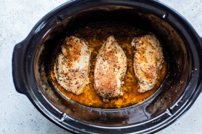 Cooked chicken breasts in a crockpot.