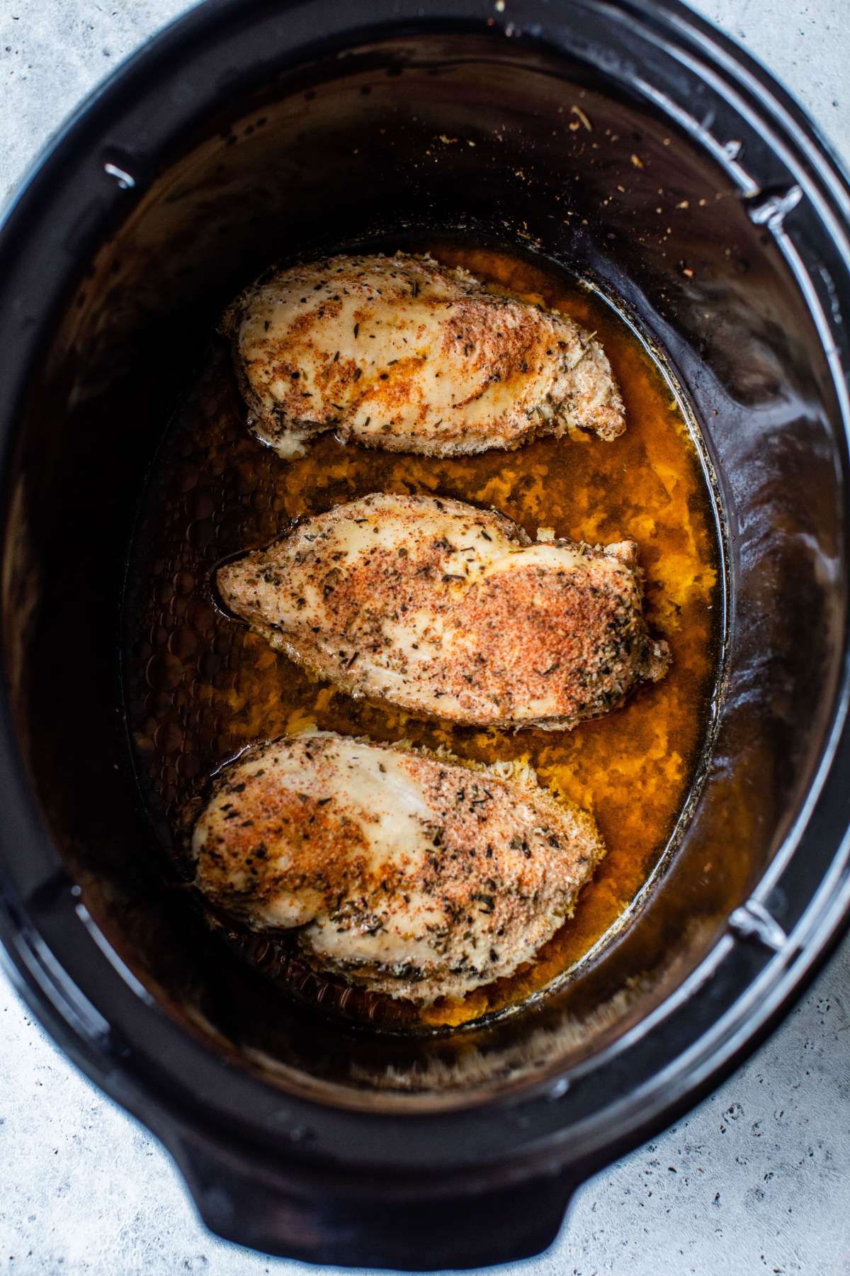Cooked chicken breasts in a crockpot.