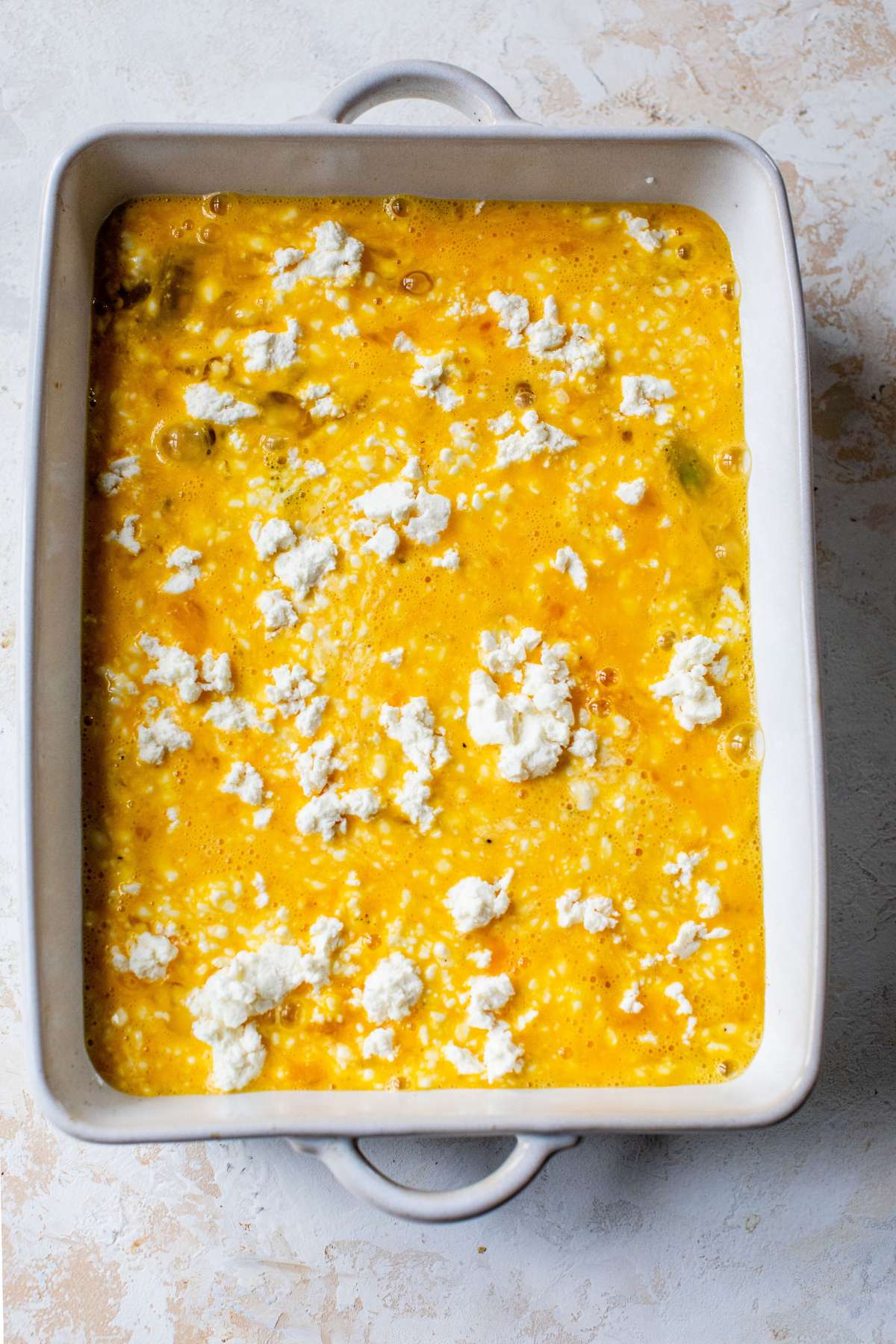 Pour eggs into dish and sprinkle with feta cheese.