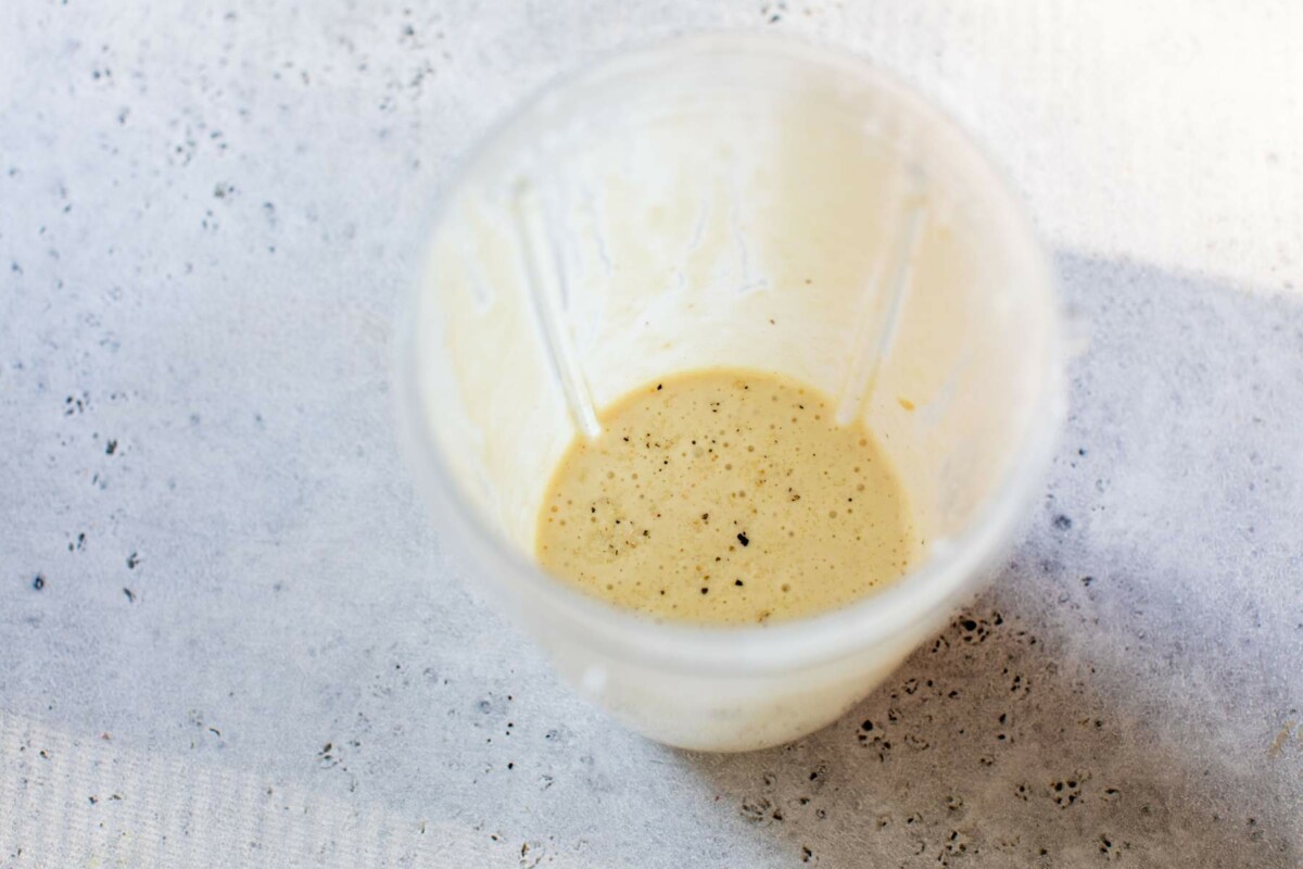 Caesar salad dressing mixed in a small blender bottle.
