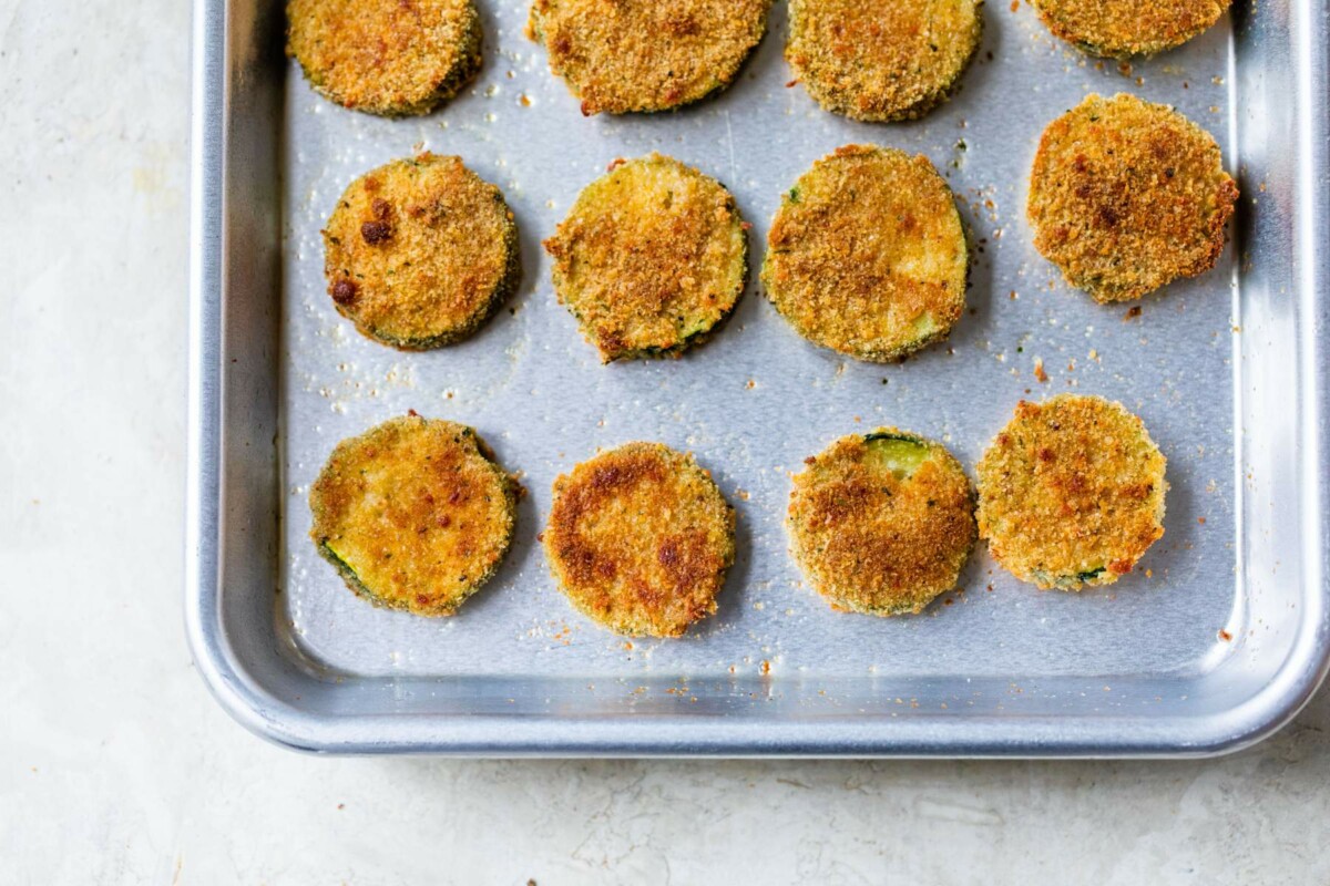 Crispy baked zucchini chips on a pan.