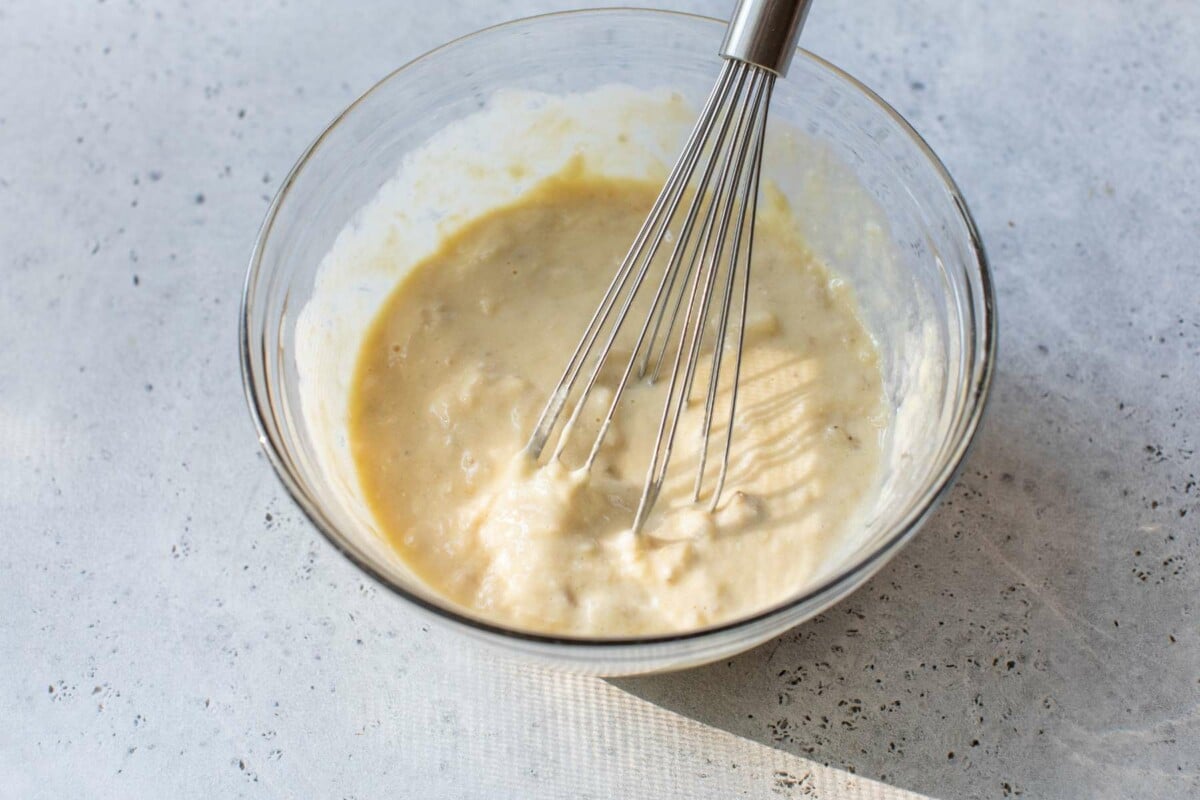 Combining Greek yogurt with eggs and mashed banana.