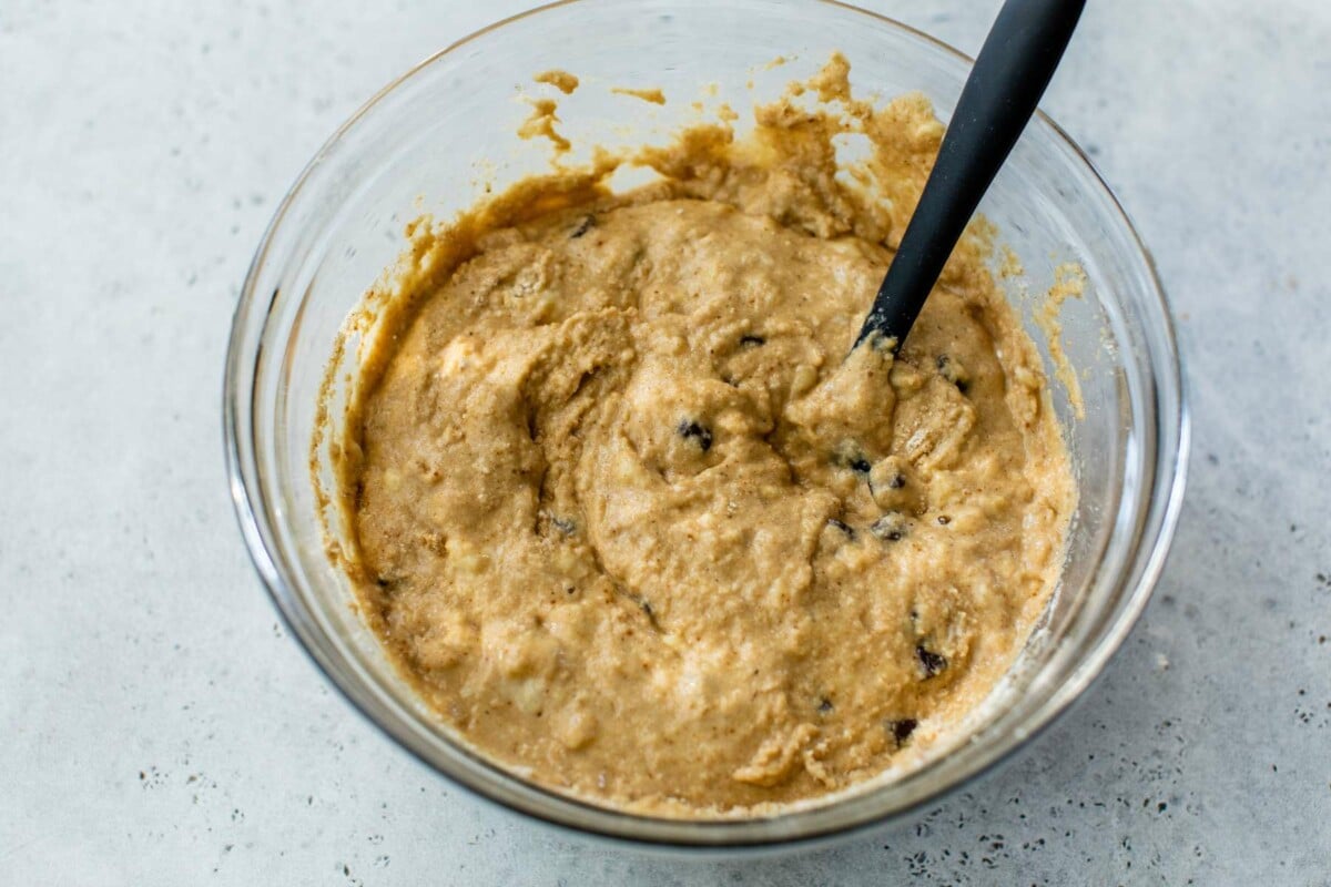 Stirring banana and flour mixture in a large bowl.